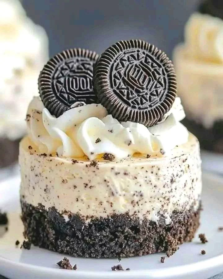 Summer Oreo cheesecake cups topped with crushed Oreos and whipped cream.