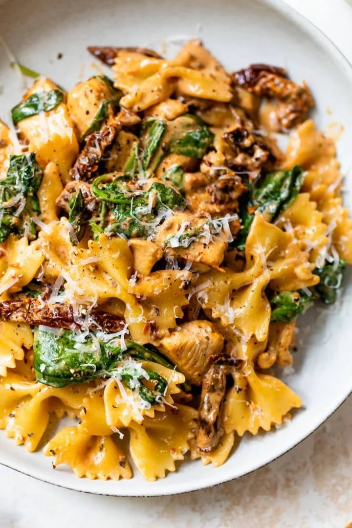 Delicious sun dried tomato pasta with chicken served on a plate