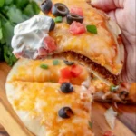 Taco Bell Mexican Pizza topped with cheese, beans, and fresh ingredients