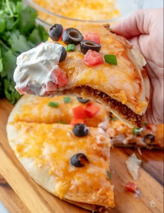 Taco Bell Mexican Pizza topped with cheese, beans, and fresh ingredients