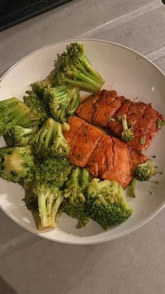 Delicious teriyaki salmon served with steamed broccoli on a plate