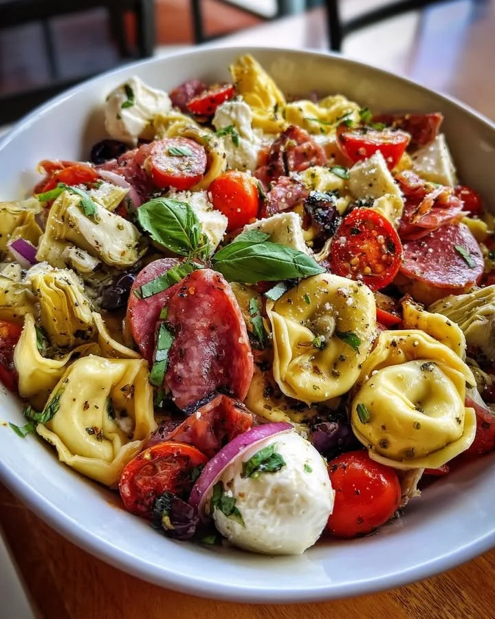 Colorful Tortellini Antipasto Salad with various vegetables and dressing