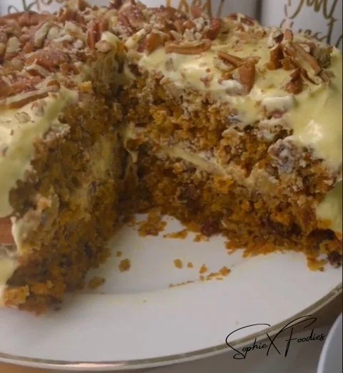 Two-layered carrot cake with cream cheese frosting and decorative carrots