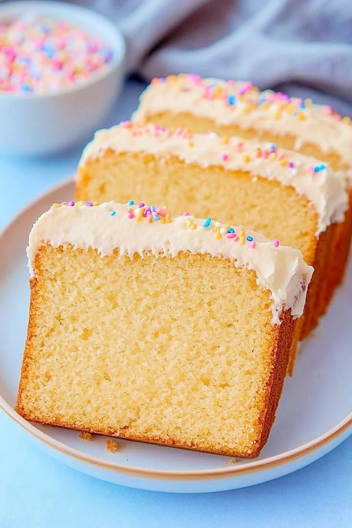 Delicious vanilla loaf cake with vibrant sprinkle frosting on top