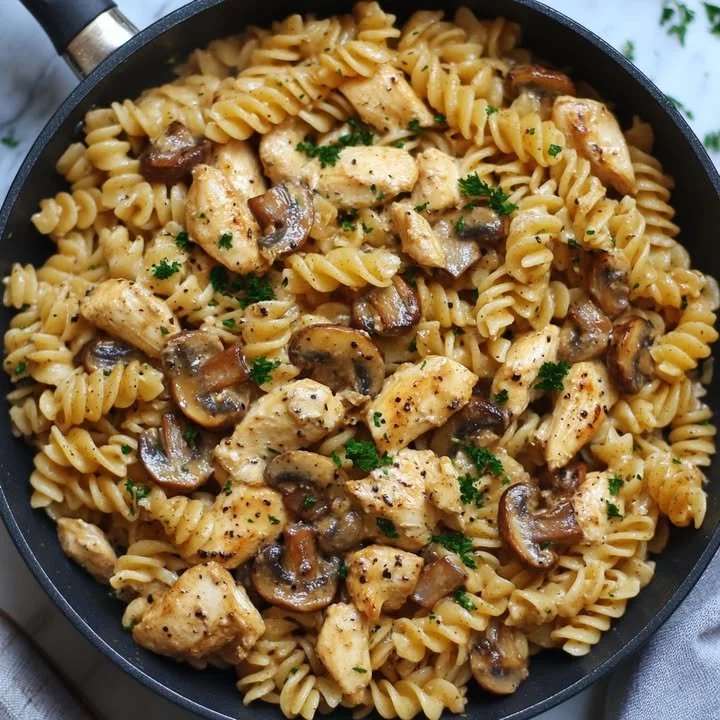 One pan velvety chicken mushroom pasta dish garnished with herbs