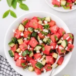 Watermelon and feta salad garnished with mint and served in a bowl