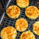 Air Fryer Zucchini Bites served on a plate, garnished with herbs.