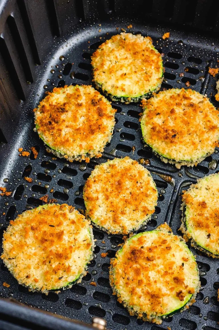 Air Fryer Zucchini Bites served on a plate, garnished with herbs.