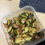 Bowl of Asian cucumber salad with fresh cucumbers and vibrant herbs