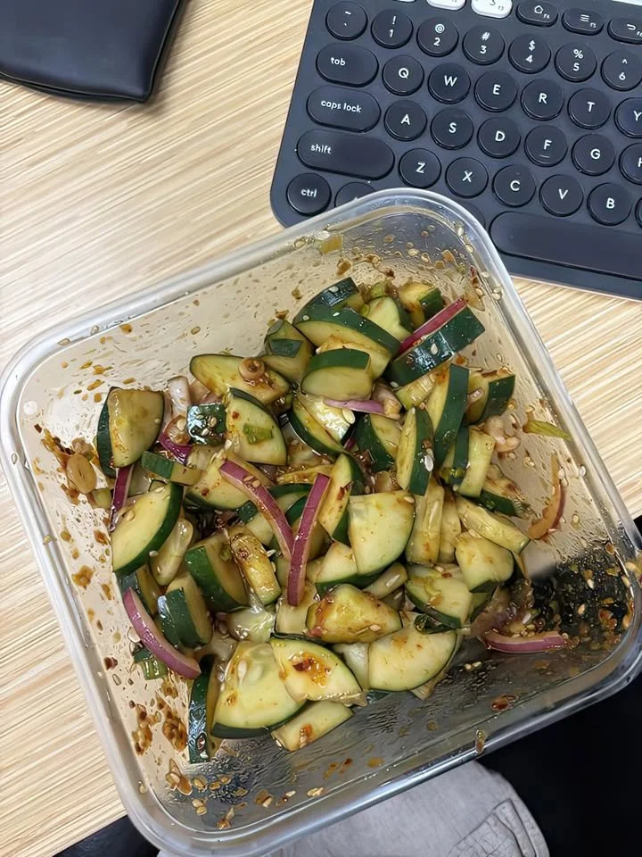Bowl of Asian cucumber salad with fresh cucumbers and vibrant herbs