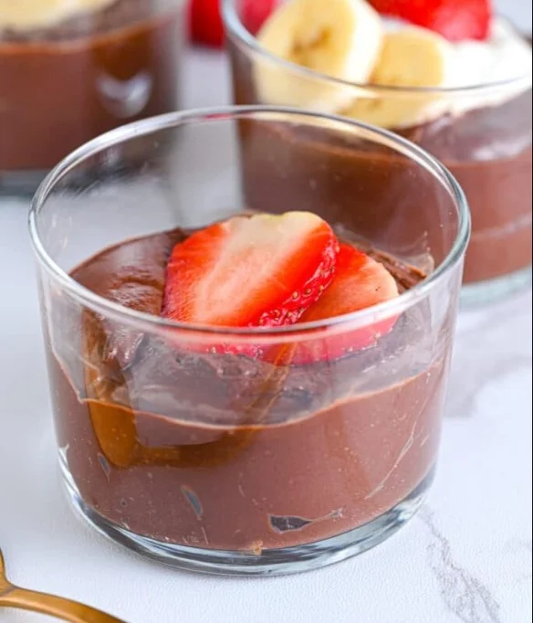 Delicious Avocado Chocolate Mousse served in a glass, garnished with cocoa powder