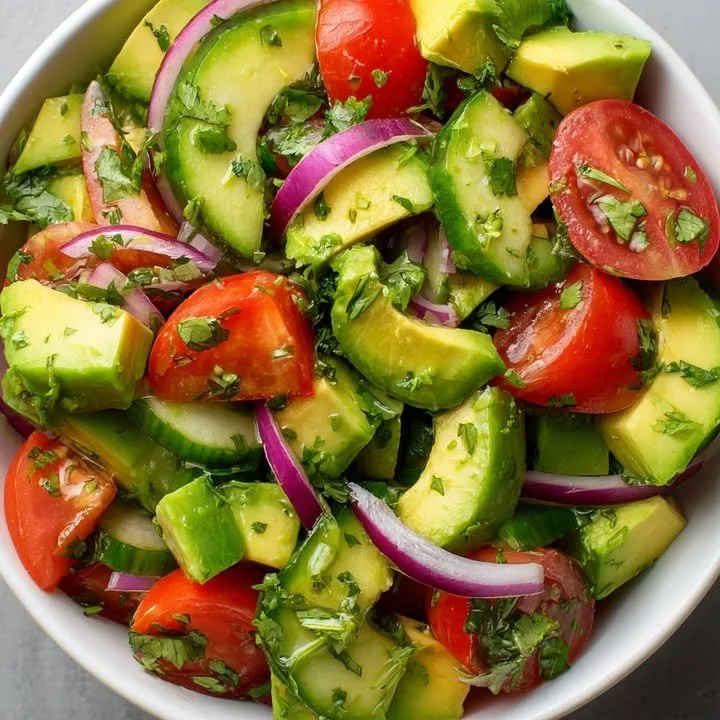 Colorful Avocado Cucumber Tomato Salad served in a bowl