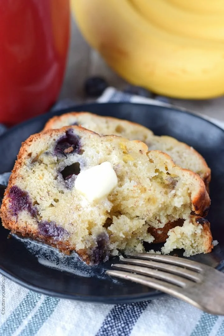 Freshly baked Banana Blueberry Bread on a wooden table