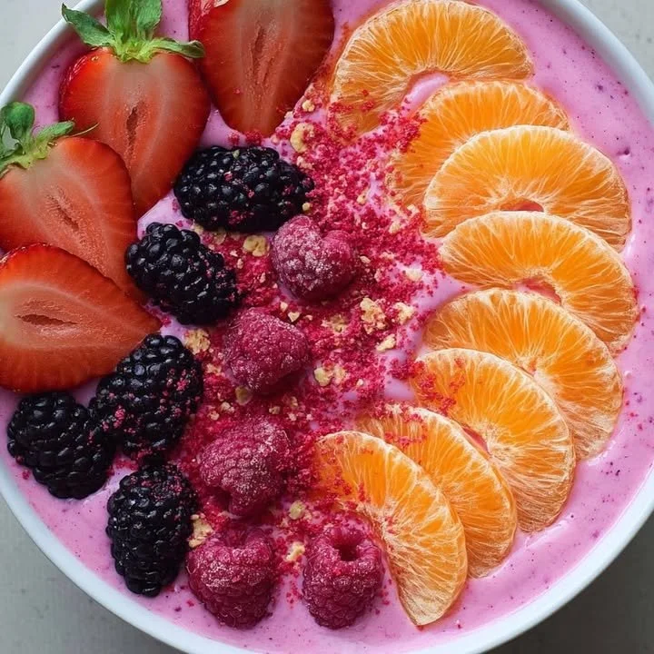 A colorful Berry Citrus Smoothie Bowl topped with fresh berries and citrus slices.