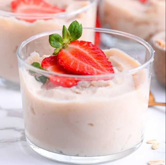A bowl of blended overnight oats topped with fruits and nuts