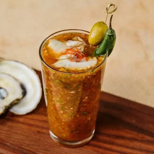 Bloody Roman, a bold beer oyster cocktail served in a stylish glass