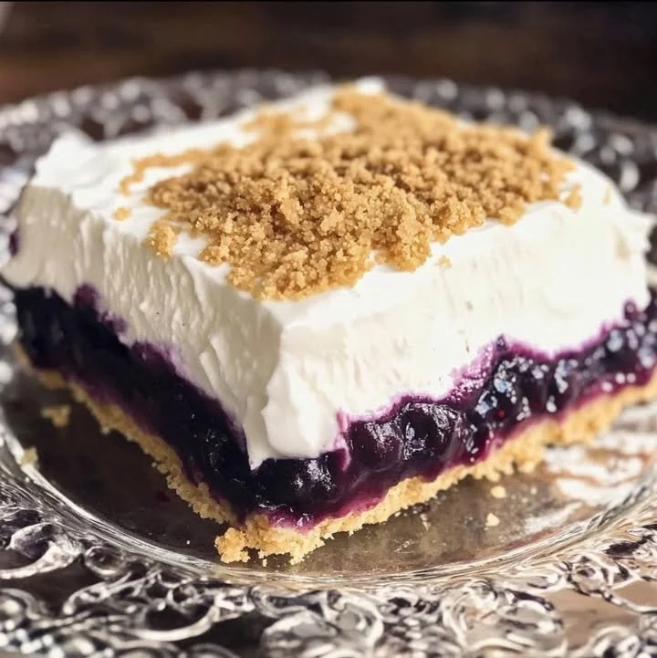 Delicious no-bake Blueberry Delight dessert garnished with fresh blueberries