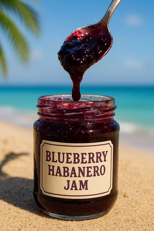 Jar of homemade Blueberry Habanero Jam with blueberries and habanero peppers
