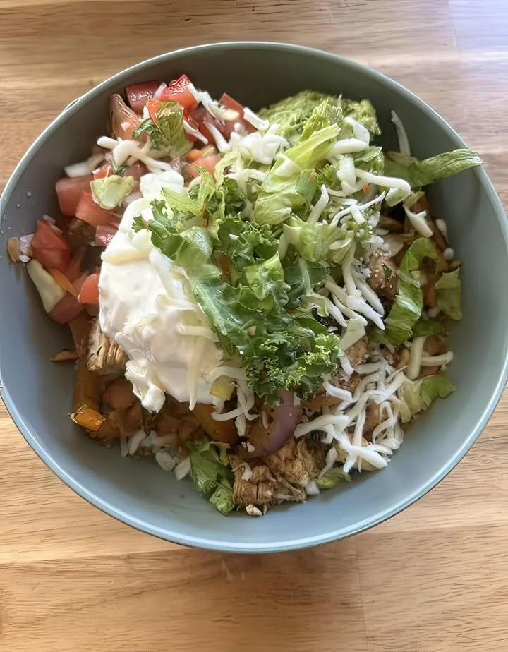 Delicious Chicken Burrito Bowl filled with chicken, rice, beans, and fresh toppings.