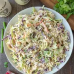 A bowl of Chipotle Lime Coleslaw with colorful vegetables and lime dressing