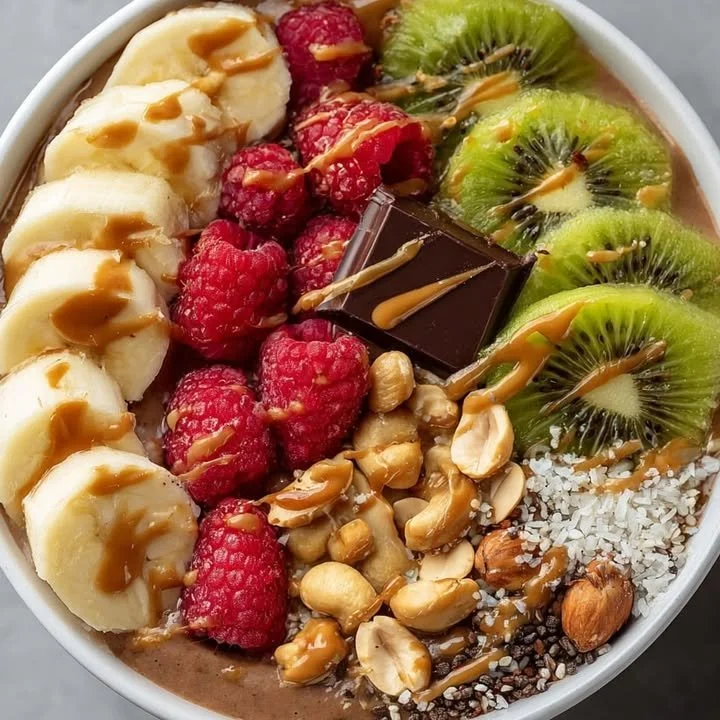 Chocolate Banana Kiwi Smoothie Bowl topped with fresh fruit and nuts