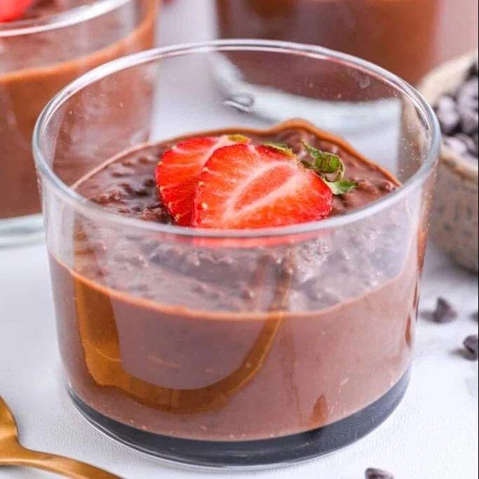 Delicious chocolate chia pudding served in a bowl topped with fresh berries.