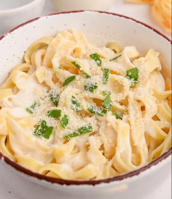 Creamy Cottage Cheese Alfredo Pasta served with fresh herbs