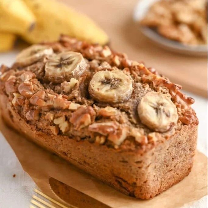 Slice of moist Cottage Cheese Banana Bread on a wooden table.