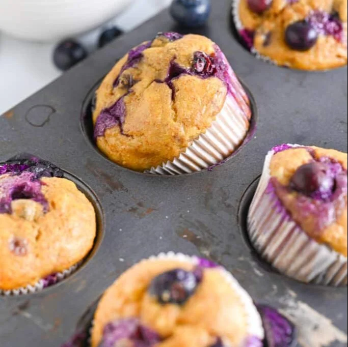 Fresh cottage cheese blueberry muffins on a wooden table
