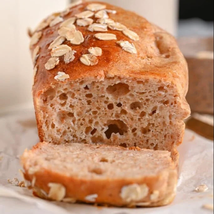 Freshly baked Cottage Cheese Bread loaf on a wooden cutting board