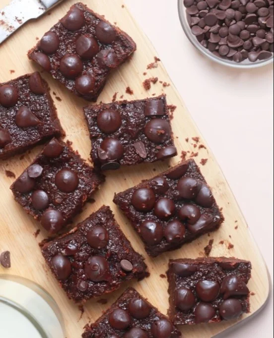 Delicious cottage cheese brownies on a plate topped with chocolate drizzle