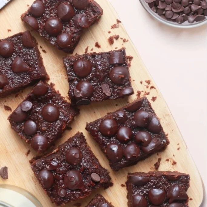 Fudgy Cottage Cheese Brownies topped with chocolate glaze and nuts