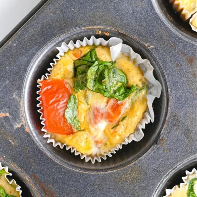 Deliciously baked Cottage Cheese Egg Bites topped with herbs and veggies.