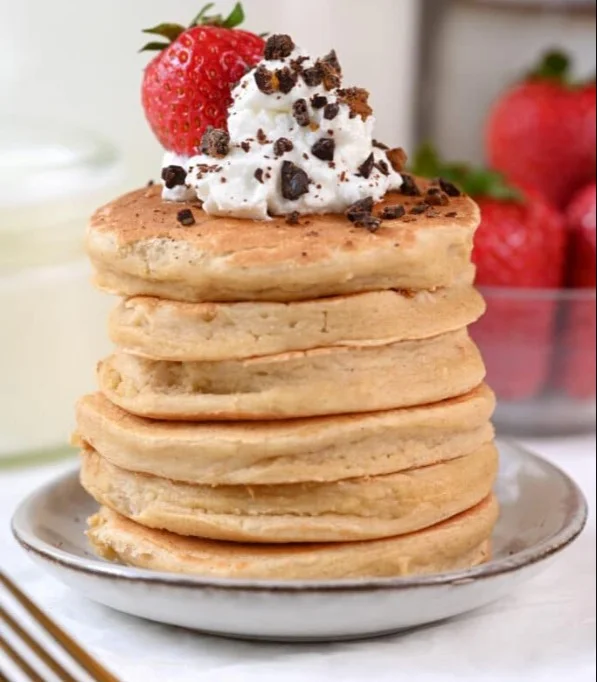 Fluffy cottage cheese pancakes topped with fresh fruits and syrup