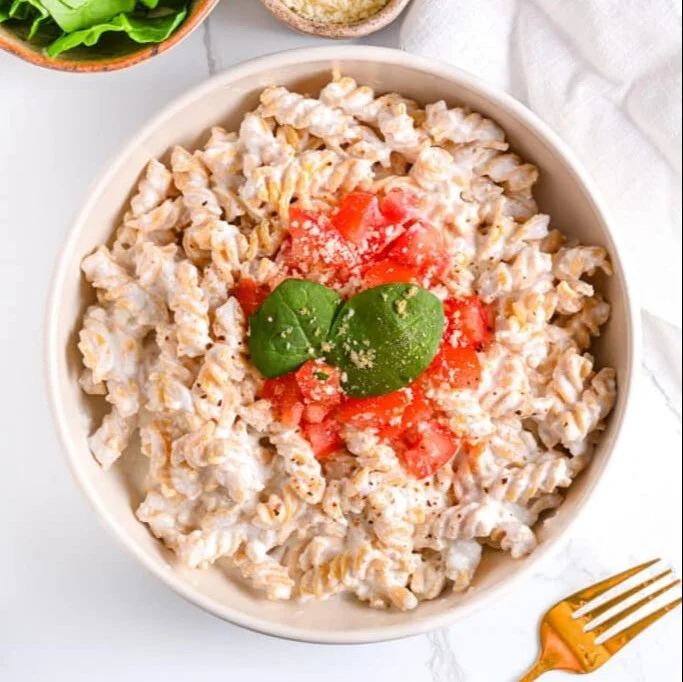 Bowl of creamy cottage cheese pasta sauce with pasta and fresh herbs