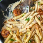 Delicious creamy garlic shrimp pasta served with herbs and ingredients.