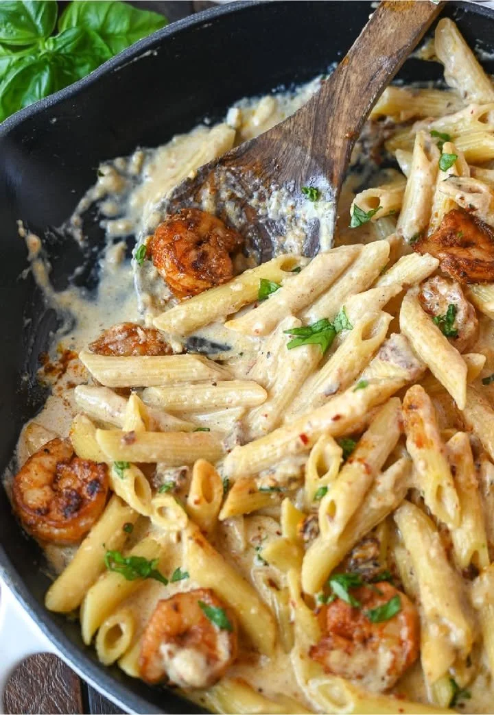 Delicious creamy garlic shrimp pasta served with herbs and ingredients.