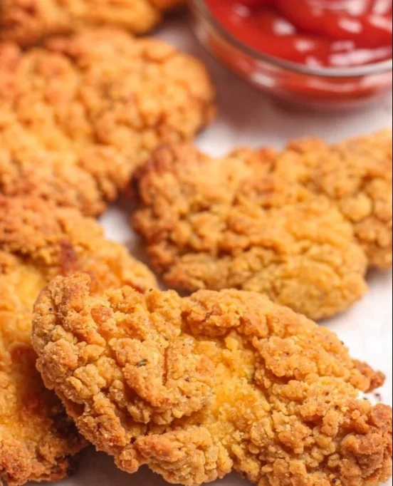 Crispy air fryer chicken tenders served on a plate with dipping sauce