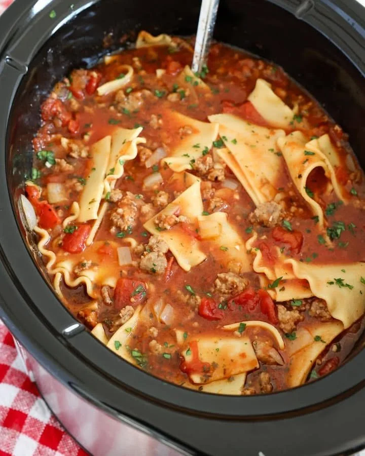 Crockpot Lasagna Soup served in a bowl with cheese and herbs