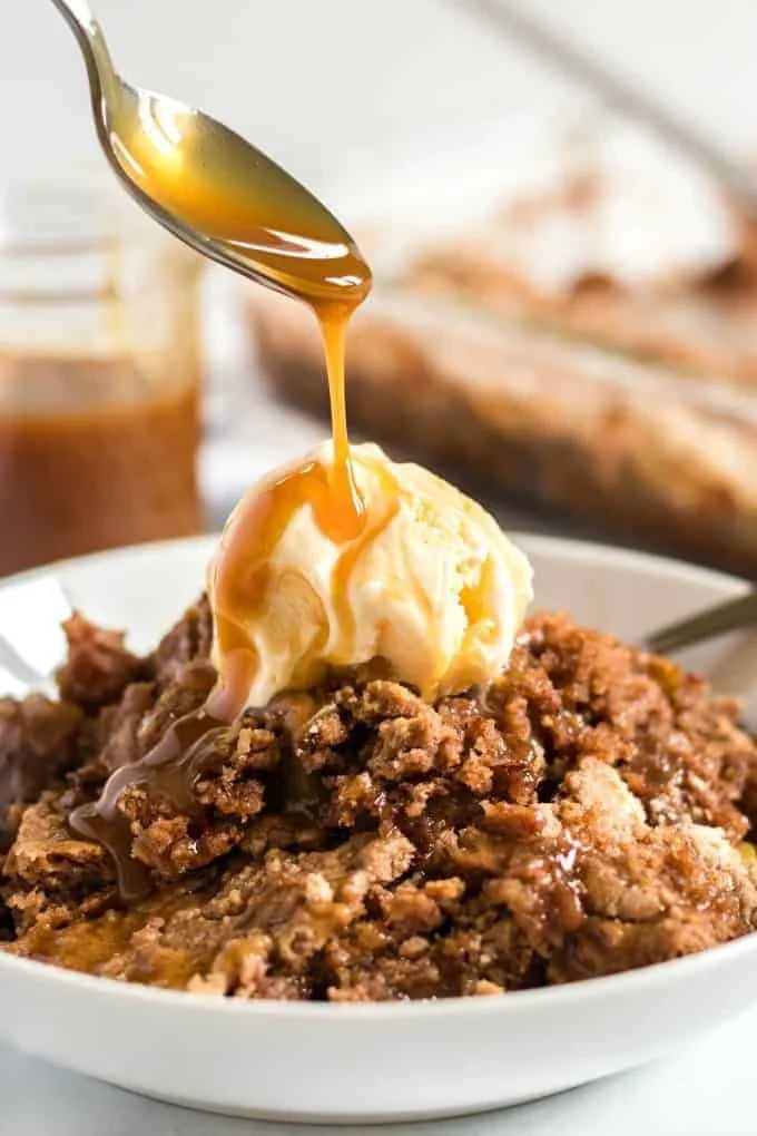 Delicious Easy Apple Dump Cake dessert served with a scoop of ice cream