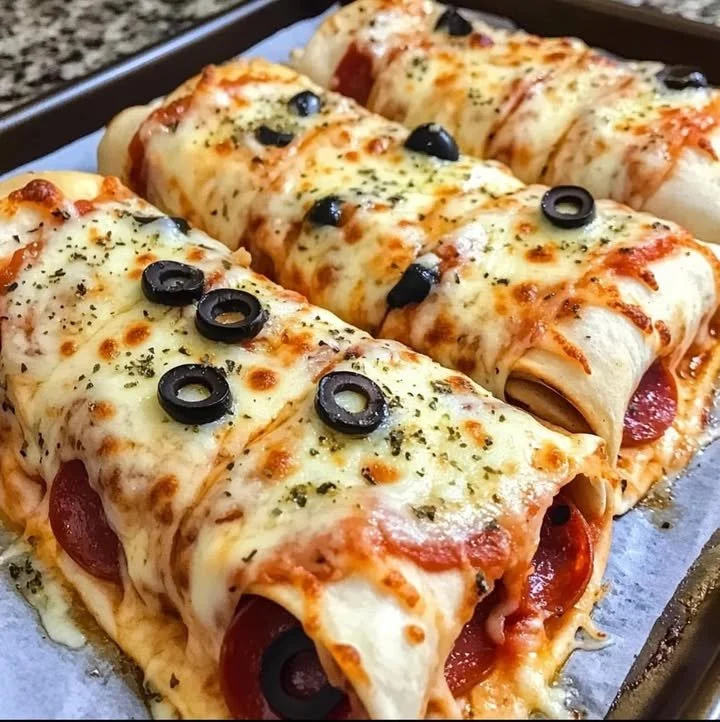 Easy baked pizza wraps with melted cheese and toppings on a plate