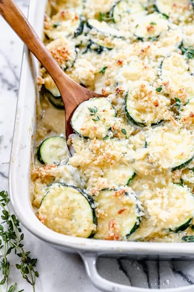 A delicious zucchini casserole baked with cheese and herbs on a serving dish.