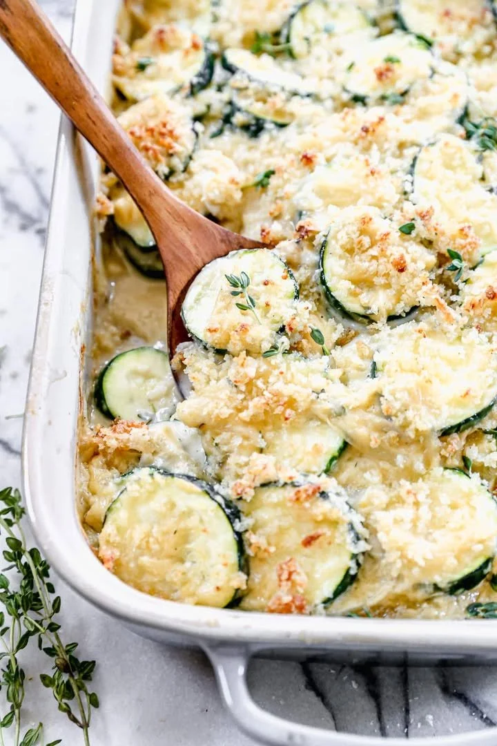 A delicious zucchini casserole baked with cheese and herbs on a serving dish.