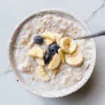 Delicious bowl of egg white oatmeal topped with fruits and nuts