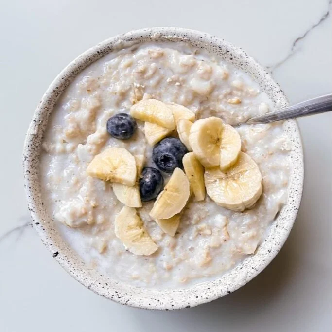 Delicious bowl of egg white oatmeal topped with fruits and nuts