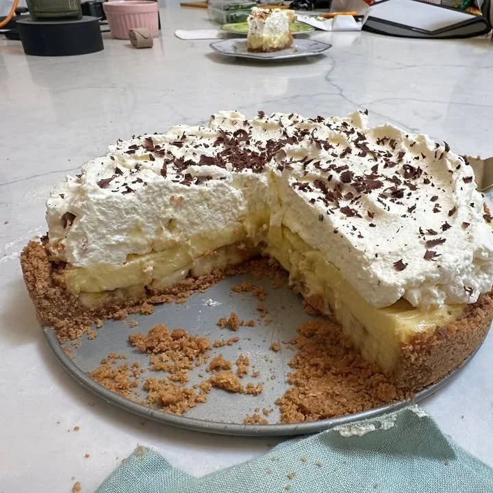 Epic banana cream pie with a Nutter Butter crust, topped with fresh bananas and whipped cream.