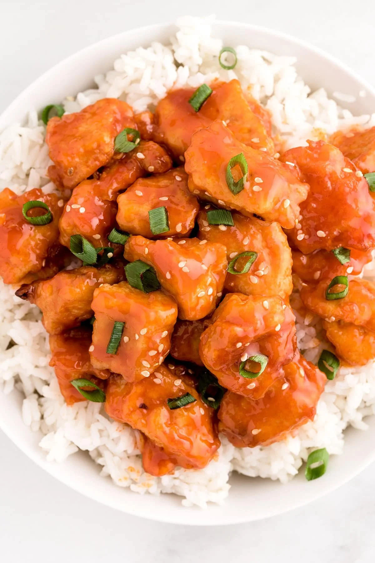 Delicious Firecracker Chicken dish served on a plate with vibrant vegetables.