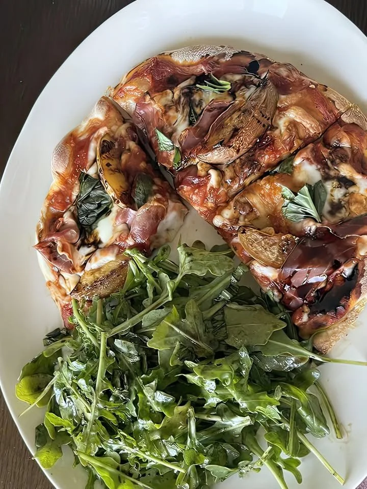 Flatbread pizza with prosciutto, eggplant, mozzarella, and arugula salad
