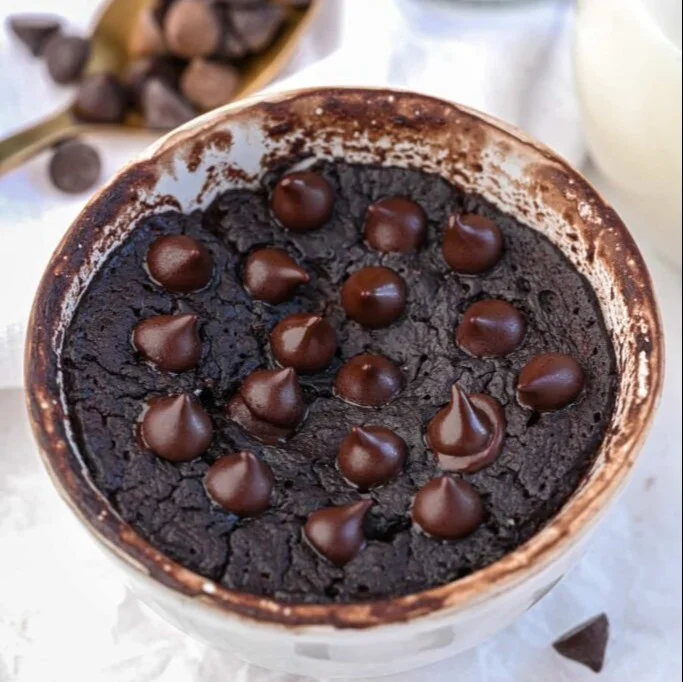 Delicious flourless protein brownie mug cakes ready to enjoy in a mug.