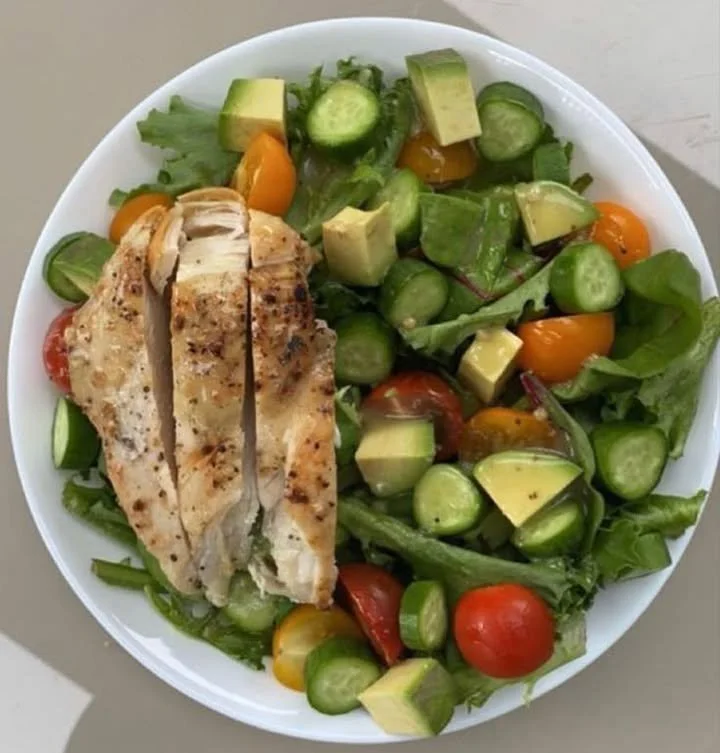 A fresh and colorful bowl of food salad with mixed vegetables and dressing